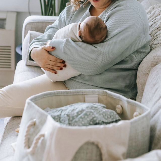 An existing client of Dr. Kimberly holding her newborn baby.