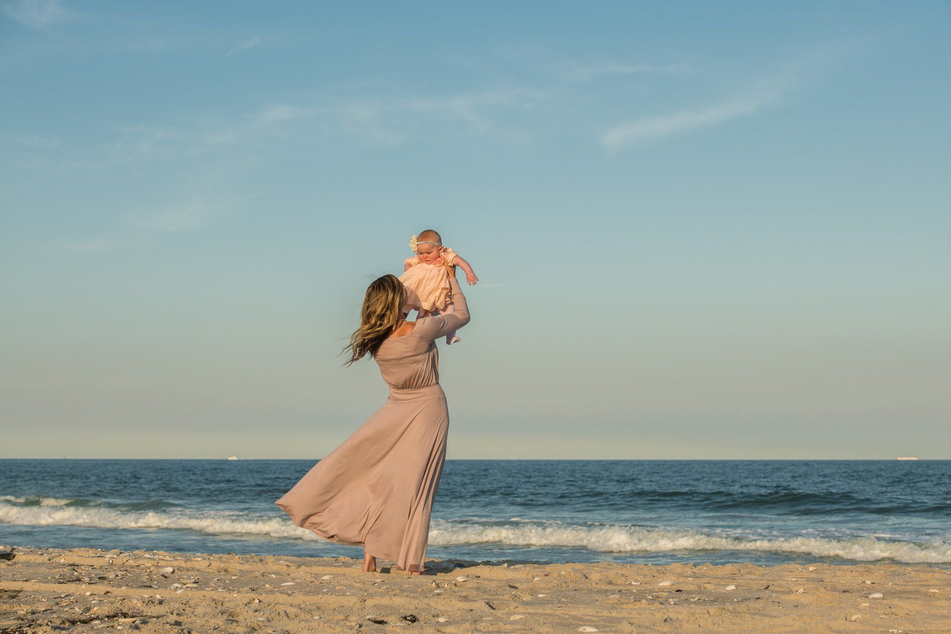 Dr. Kimberly with her baby at the beach.