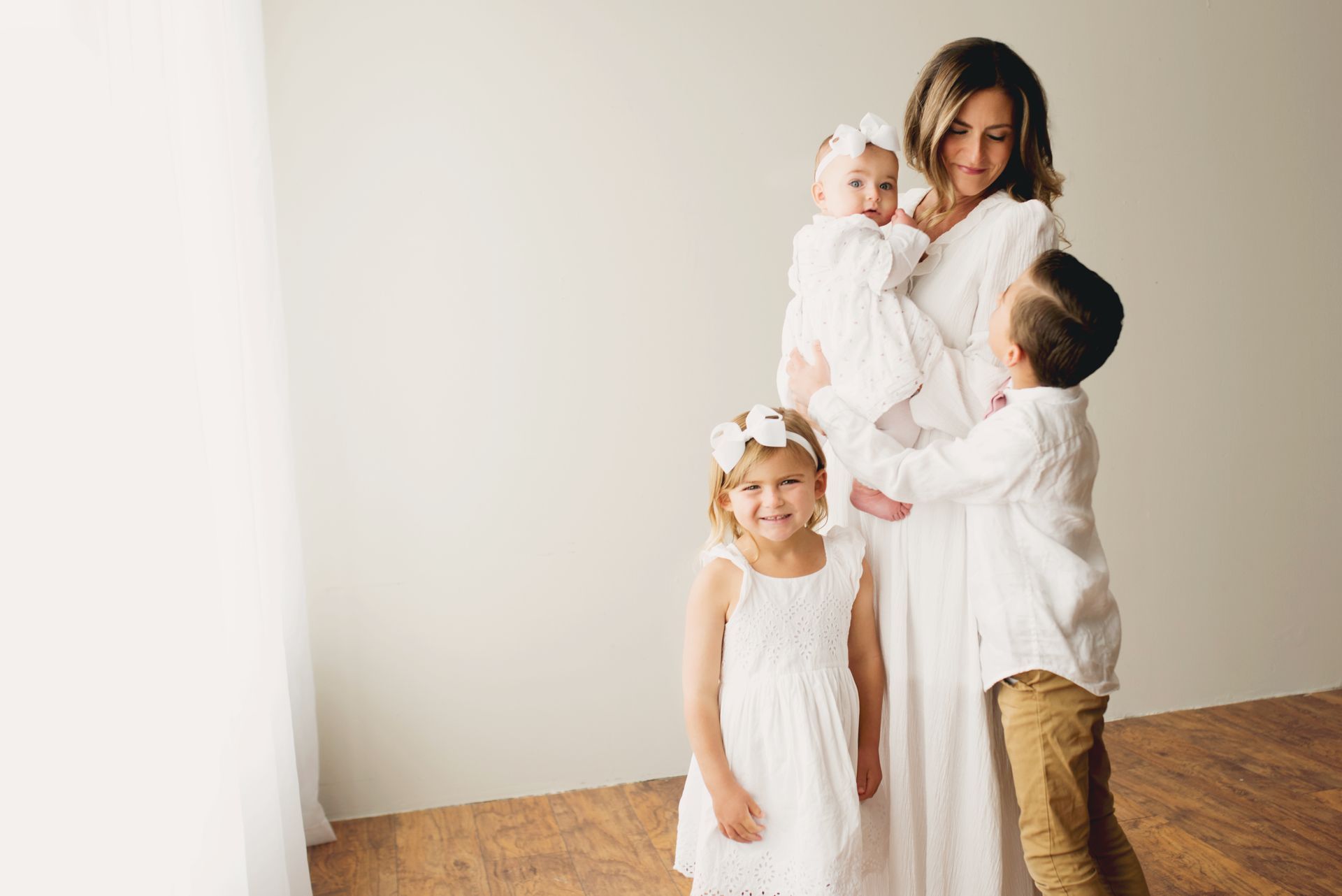 Health coach Dr. Kimberly and her three children all wearing white.