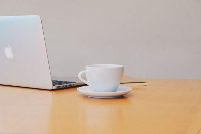 A cup of tea and a laptop ready for a virtual consultation for existing clients.