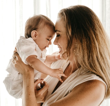 A young mother holding her baby.